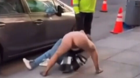 Two girls fighting in street - one with wardrobe malfunction