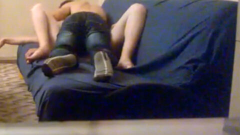 Amateur mother and son sharing a hidden intimate encounter on a worn family couch