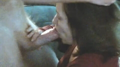 A clothed mother on her knees performs oral sex on her naked son in raw amateur incest footage.